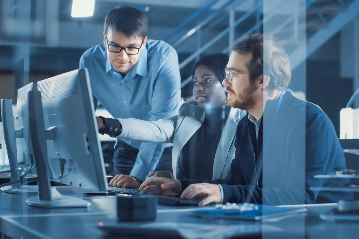 Electronics Development Engineer Working on Computer, Talks with Project Manager, Another Specialist Joins Discussion. Team of Professionals Use CAD Software for Modern Industrial Engineering Design.