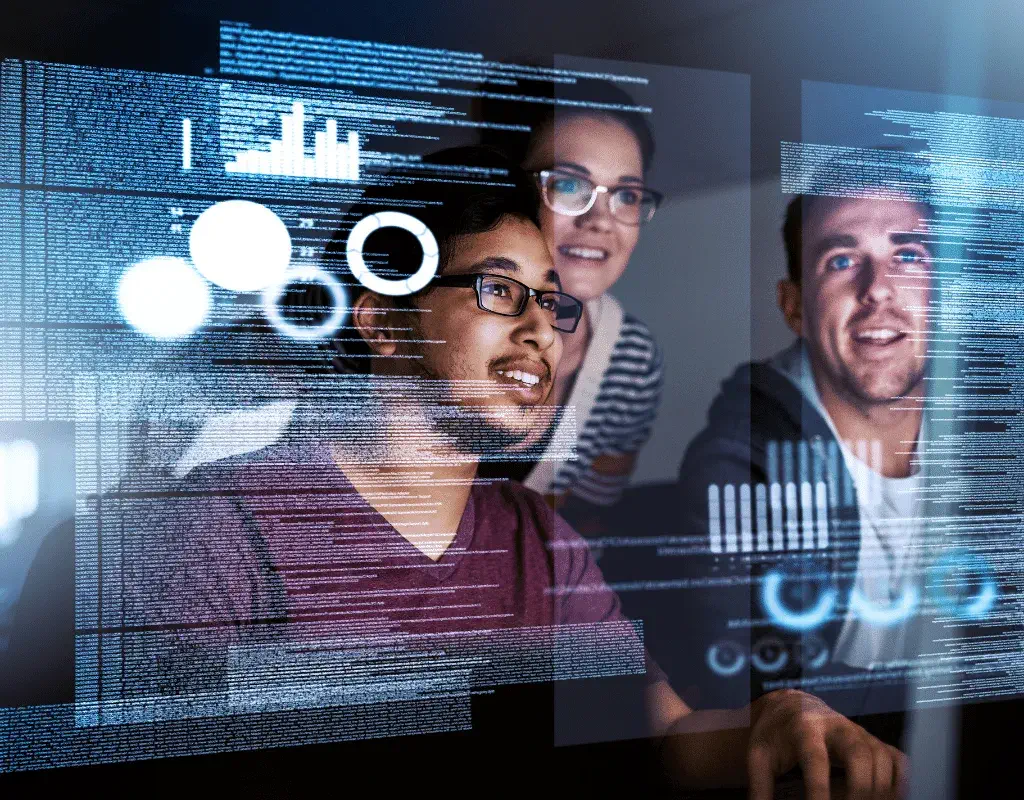 Three smiling people look at a transparent screen displaying digital code and data visualizations.